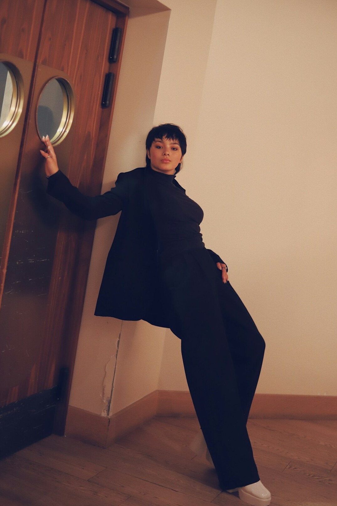 Woman in professional attire standing in an office