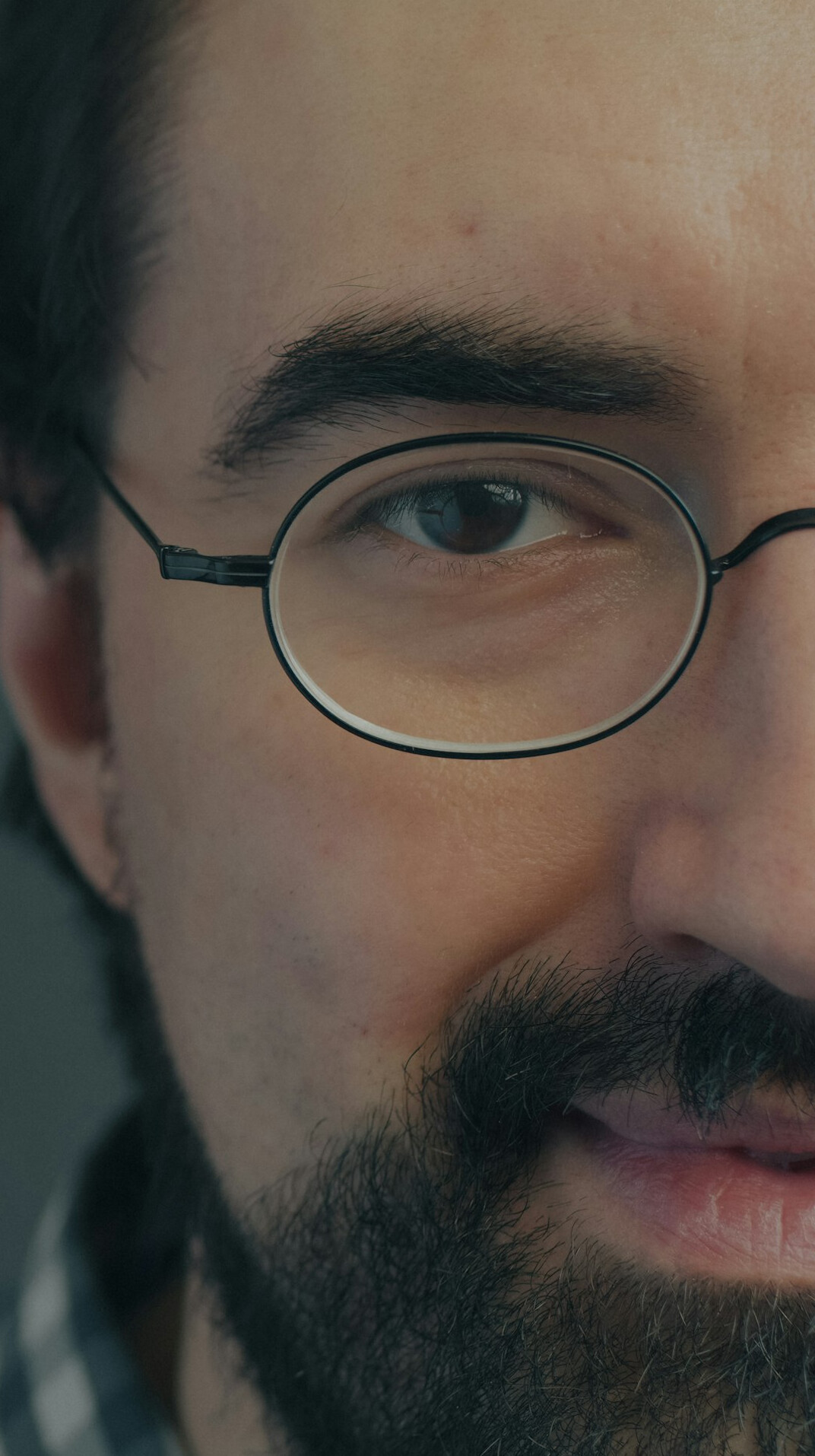 Bearded man with glasses in casual shirt