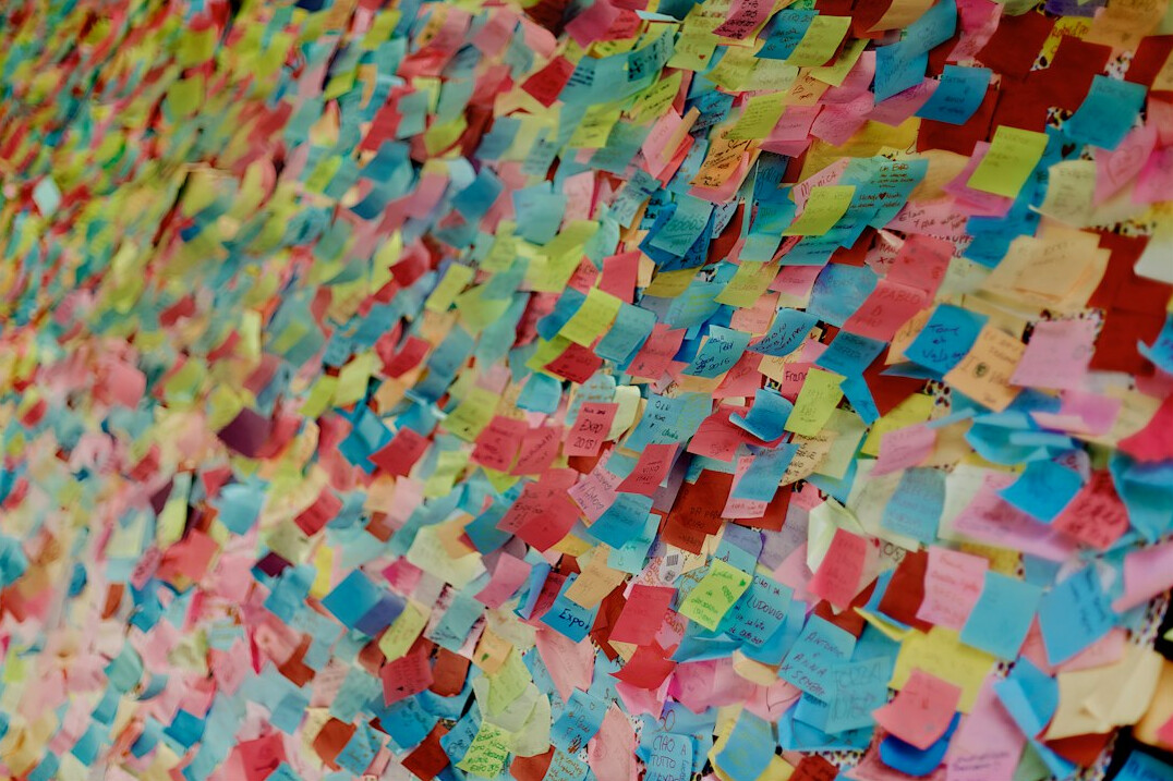 Sticky notes arranged on a wall during a workshop